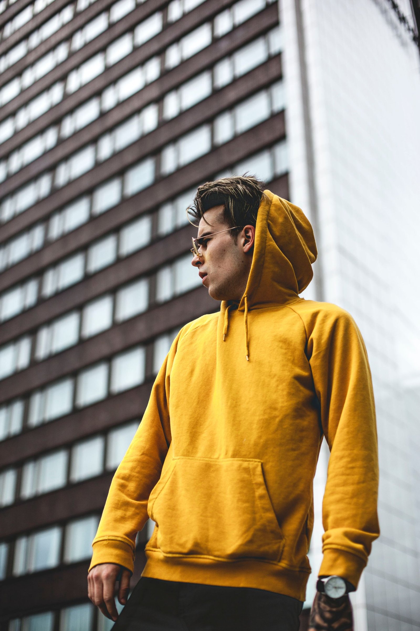 Man in overcoat walking in urban setting